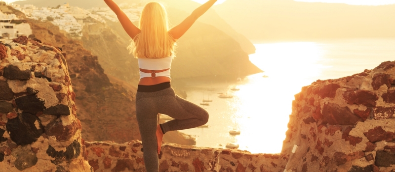 Rear view of young woman at sunset in Santorini Greece