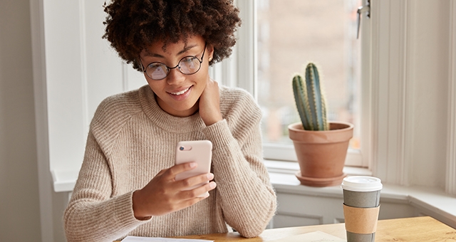 Woman holds modern smart phone